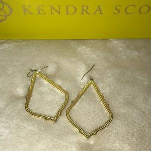 Kendra Scott gold earrings.